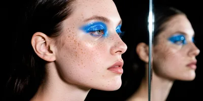 Portrait Of A Woman With Glittery Blue Eyeshadow