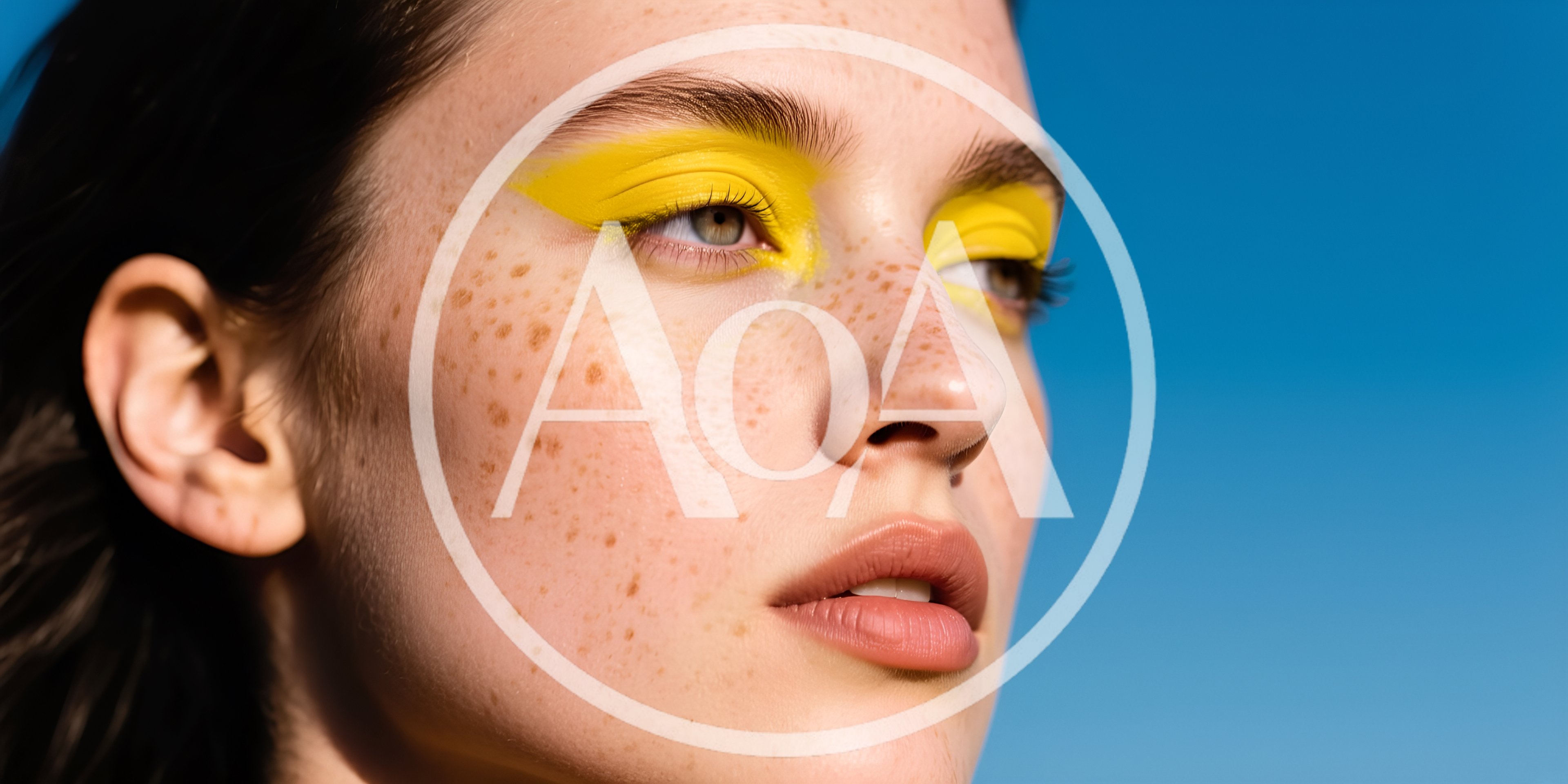 Portrait Of A Young Woman With Freckles And Yellow Eyeshadow