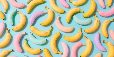 Pattern of Colorful Bananas on Light Blue Background