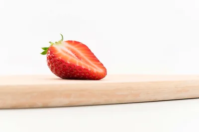 Fresh Strawberry Half On A Wooden Cutting Board