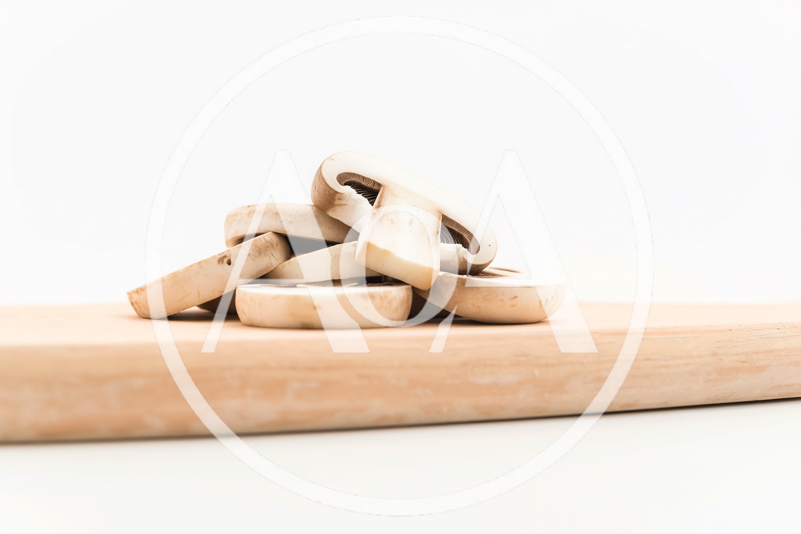 Sliced Raw Mushrooms On A Wooden Cutting Board