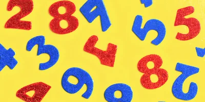 Glittery Plastic Number Magnets On Yellow Background