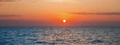 Golden Sunset Over The Calm Ocean Horizon