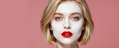Young Woman With White Face Mask And Red Lipstick