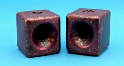 Two Glittery Red Cube Speakers On Blue Background