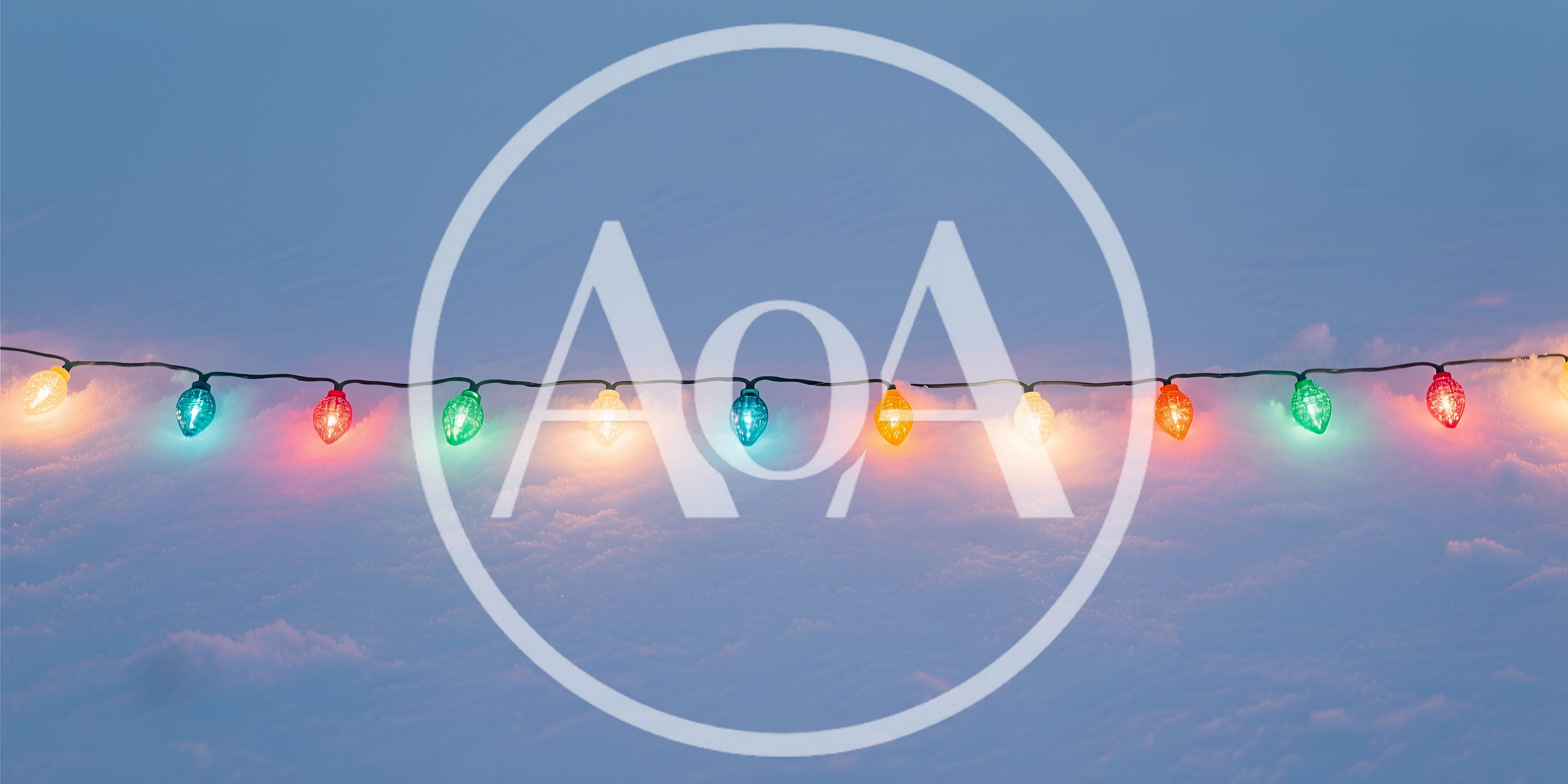 String Of Colorful Christmas Lights On Snowy Ground