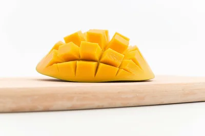 Fresh Mango Half Cubed on Wooden Cutting Board