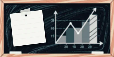 Blank Note Paper On A Blackboard With Business Chart