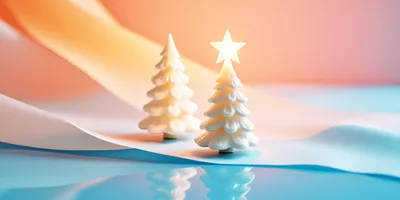 Two Miniature White Christmas Trees On Reflective Surface