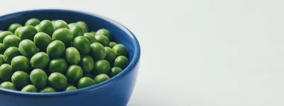 Fresh Green Peas In A Blue Bowl