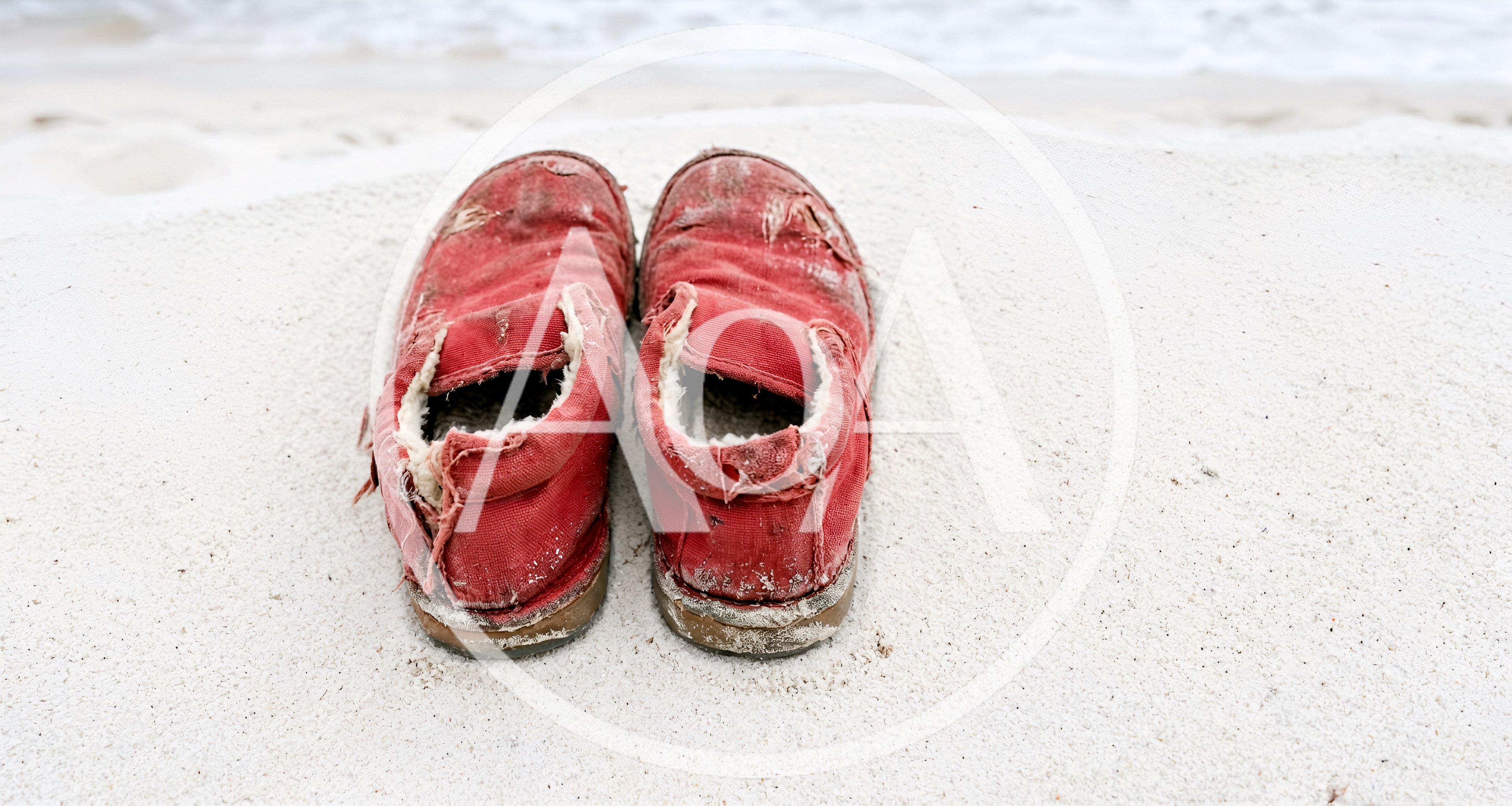 Worn Red Canvas Shoes On White Sandy Beach
