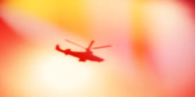 Silhouette Of A Military Attack Helicopter In Flight
