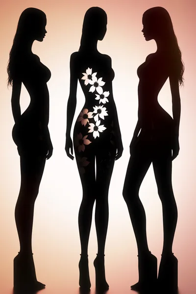 Silhouettes Of Three Women With Floral Body Cutouts