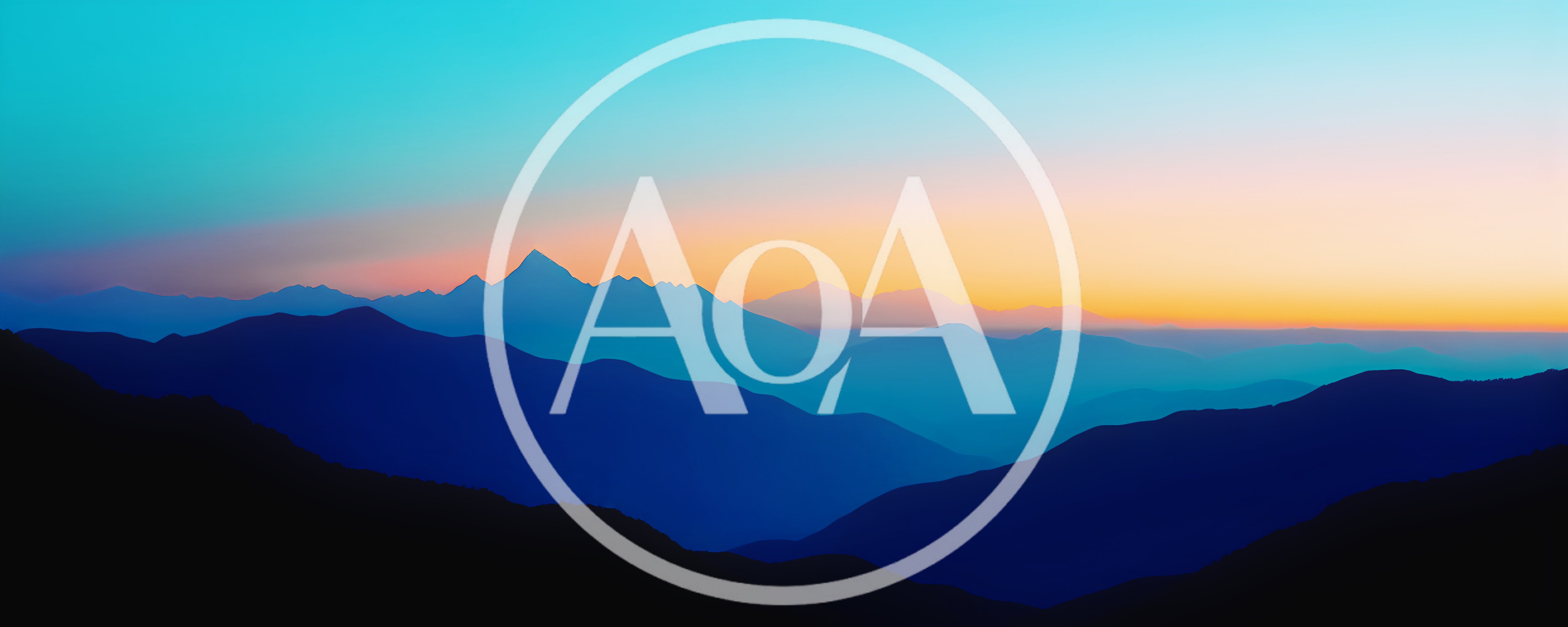 Panoramic View Of Layered Mountain Silhouettes At Sunset
