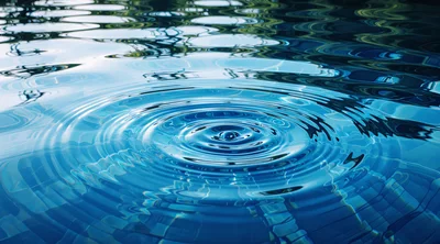 Water Droplet Creating Concentric Ripples In A Pool