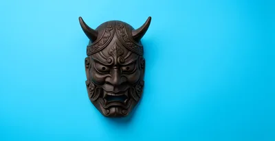 Wooden Japanese Hannya Mask on Blue Background