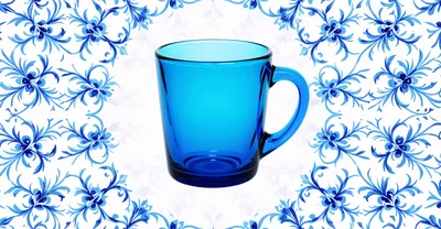 Blue Glass Mug Centered on Floral Pattern Background