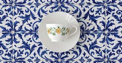 White Tea Cup and Saucer on Blue Patterned Tiles