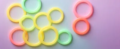 Colorful Glowing Plastic Rings On Gradient Background