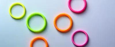 Colorful Neon Plastic Rings on Light Background