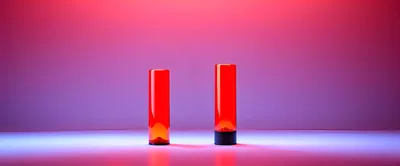 Two Red Glass Cylinders On A Gradient Background