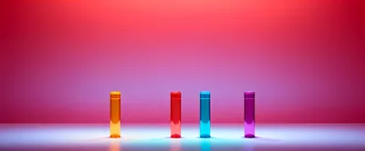 Four Colorful Glass Cylinders on a Gradient Background
