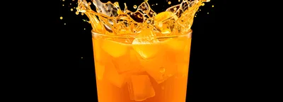 Orange Juice Splash With Ice Cubes In Glass