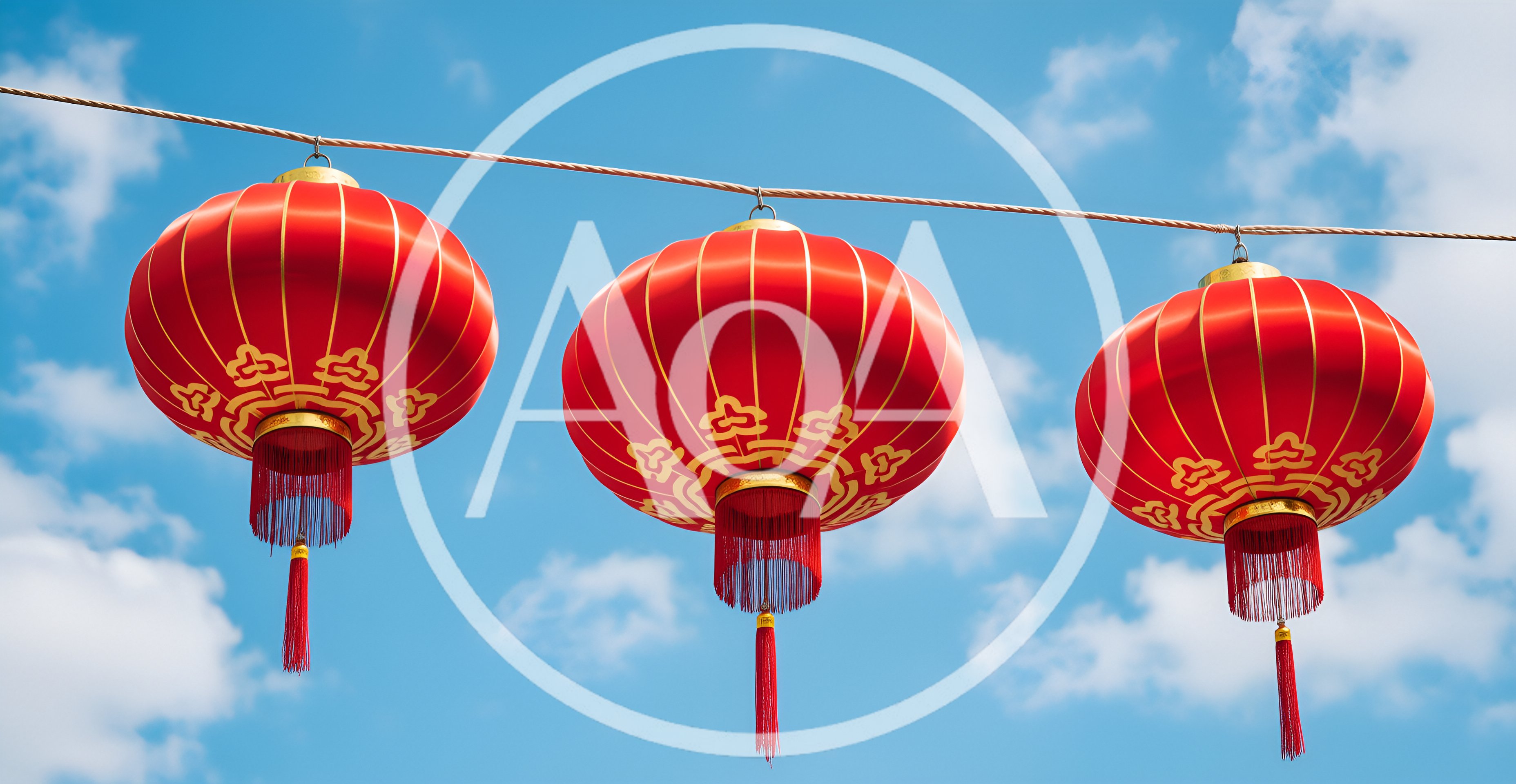 Three Traditional Red Chinese Lanterns Hanging Against Blue Sky