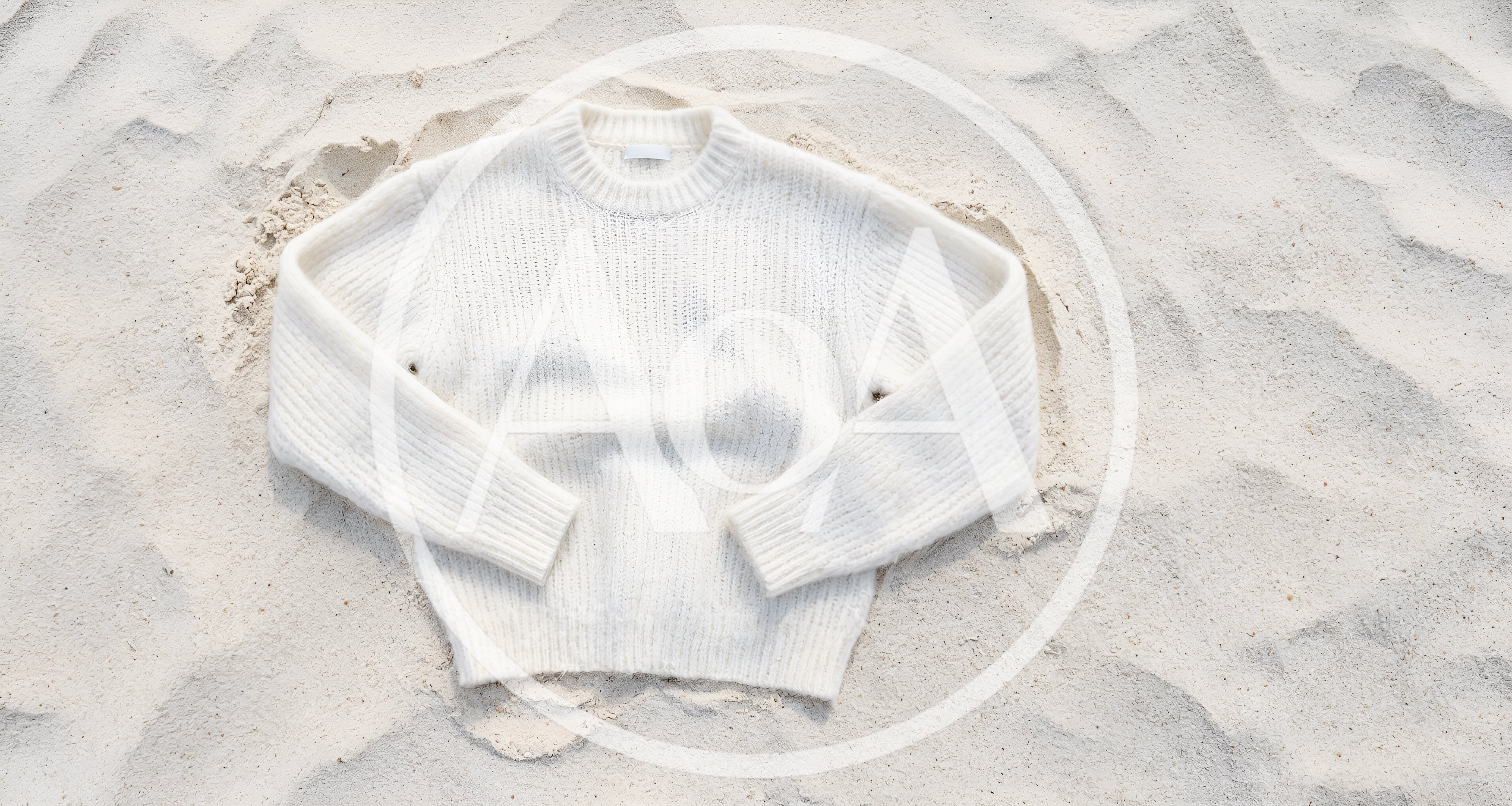 White Knitted Sweater Resting On Sandy Beach