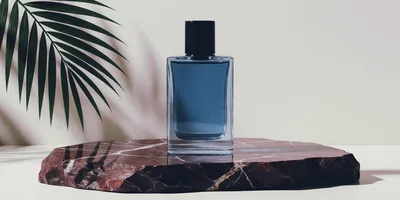 Blue Perfume Bottle On A Marble Stone Pedestal