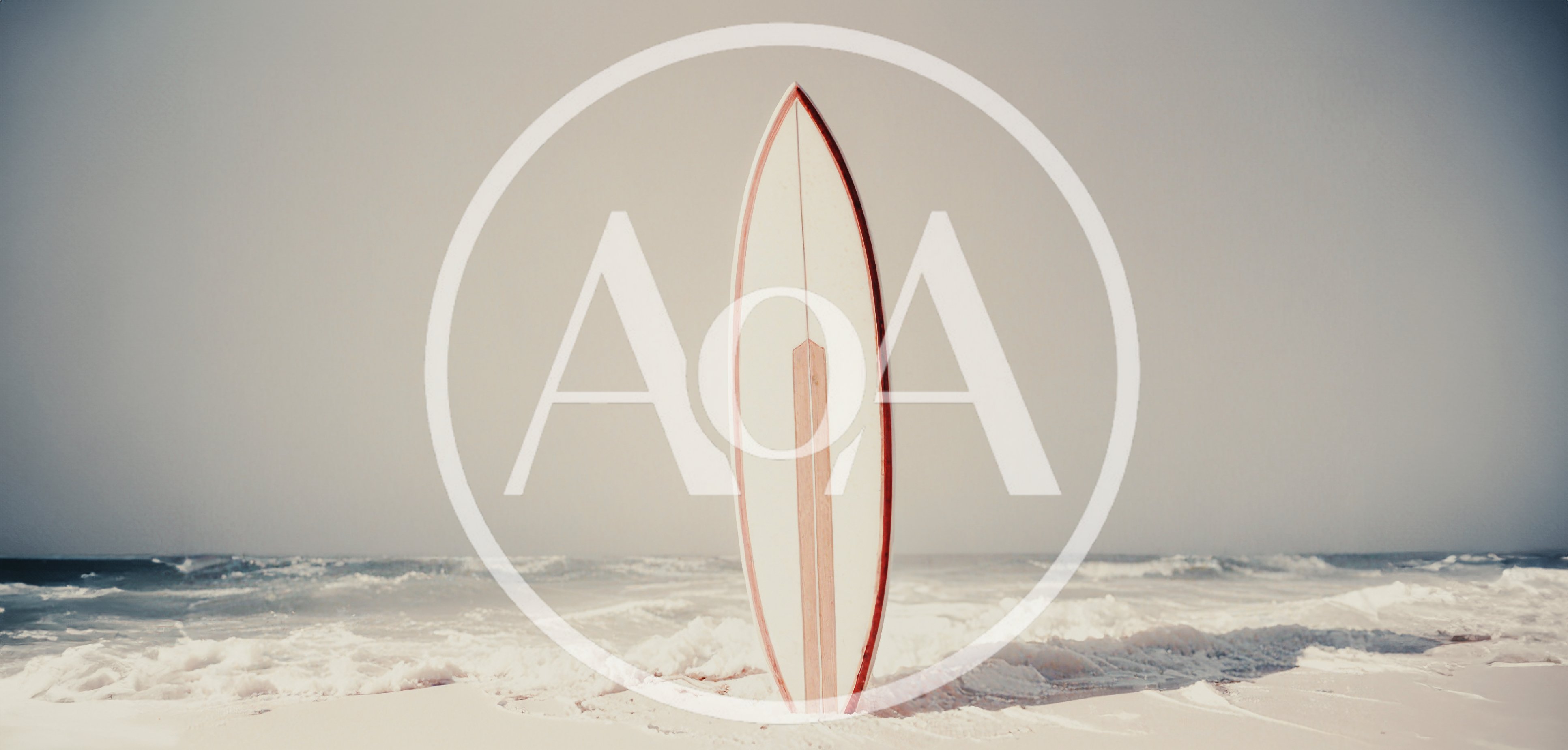 Vintage Surfboard Standing Upright On A Sandy Beach
