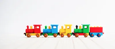 Colorful Wooden Toy Train Set On White Surface