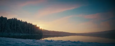 Winter Sunrise Over A Snowy Forest Lake