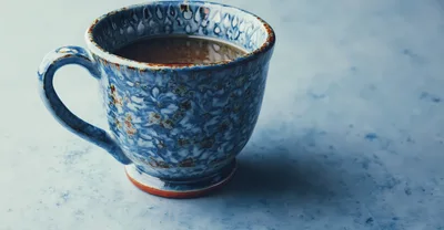 Artisan Ceramic Coffee Mug On Textured Blue Surface