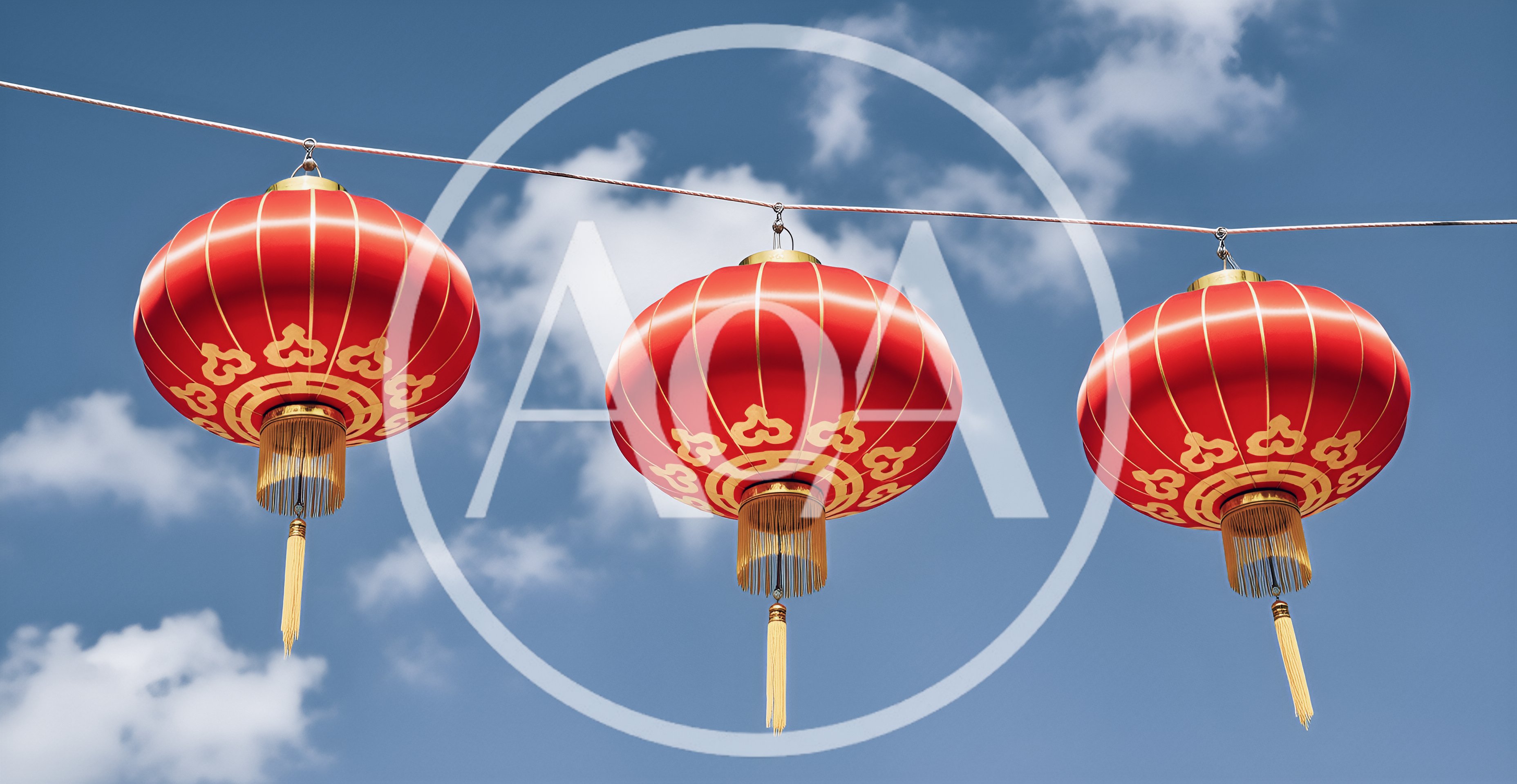 Three Traditional Red Chinese Lanterns Hanging Against Blue Sky