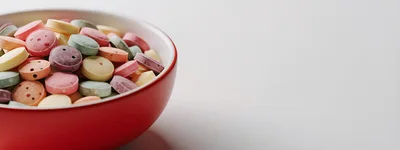 Colorful Candy Tablets in a Red Bowl