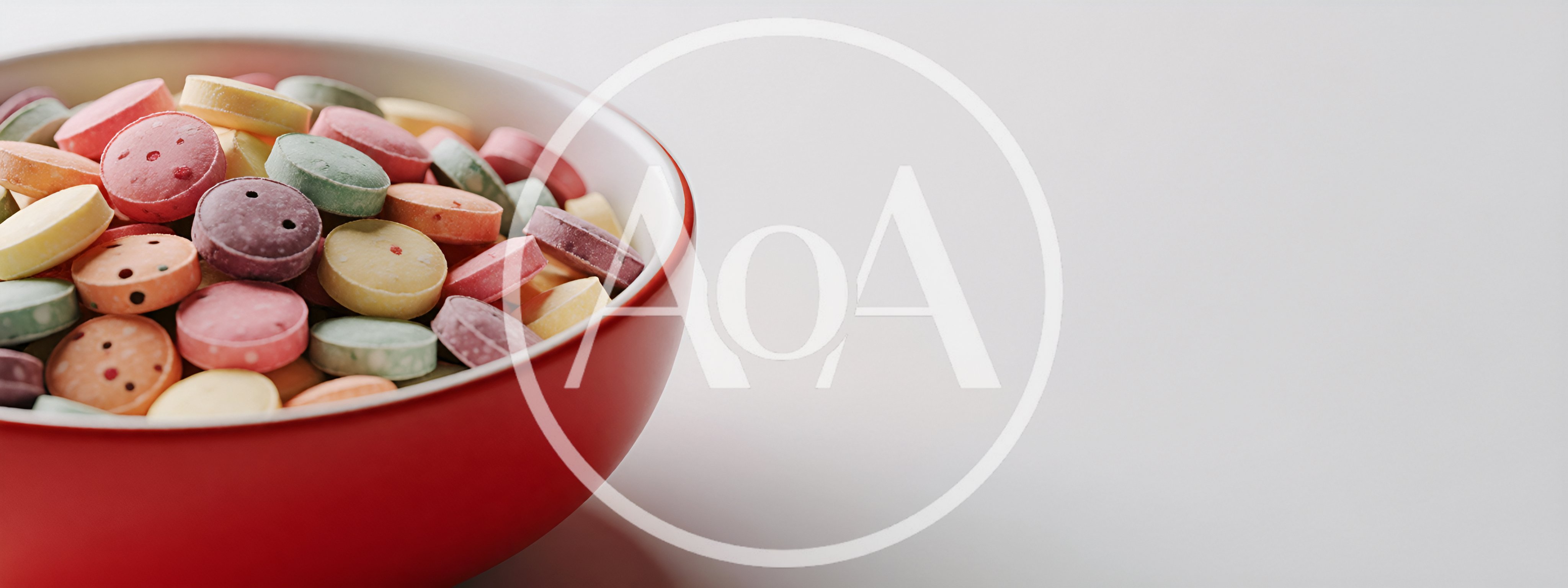 Colorful Candy Tablets in a Red Bowl