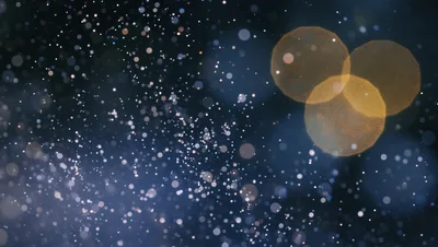 Abstract Background With Floating Golden And Blue Bokeh Particles