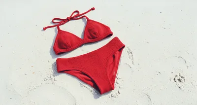 Red Knitted Bikini Set On White Sand Beach