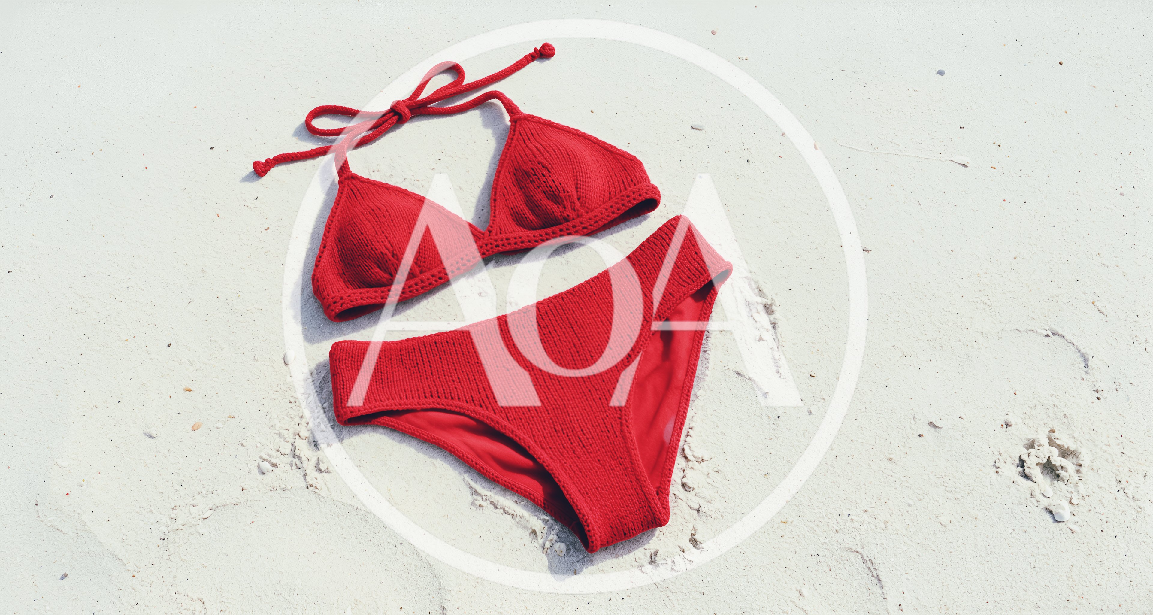 Red Knitted Bikini Set On White Sand Beach