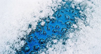 Water Droplets On A Frozen Blue Surface