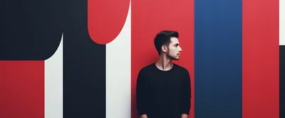 Young Man Standing Against Abstract Geometric Wall