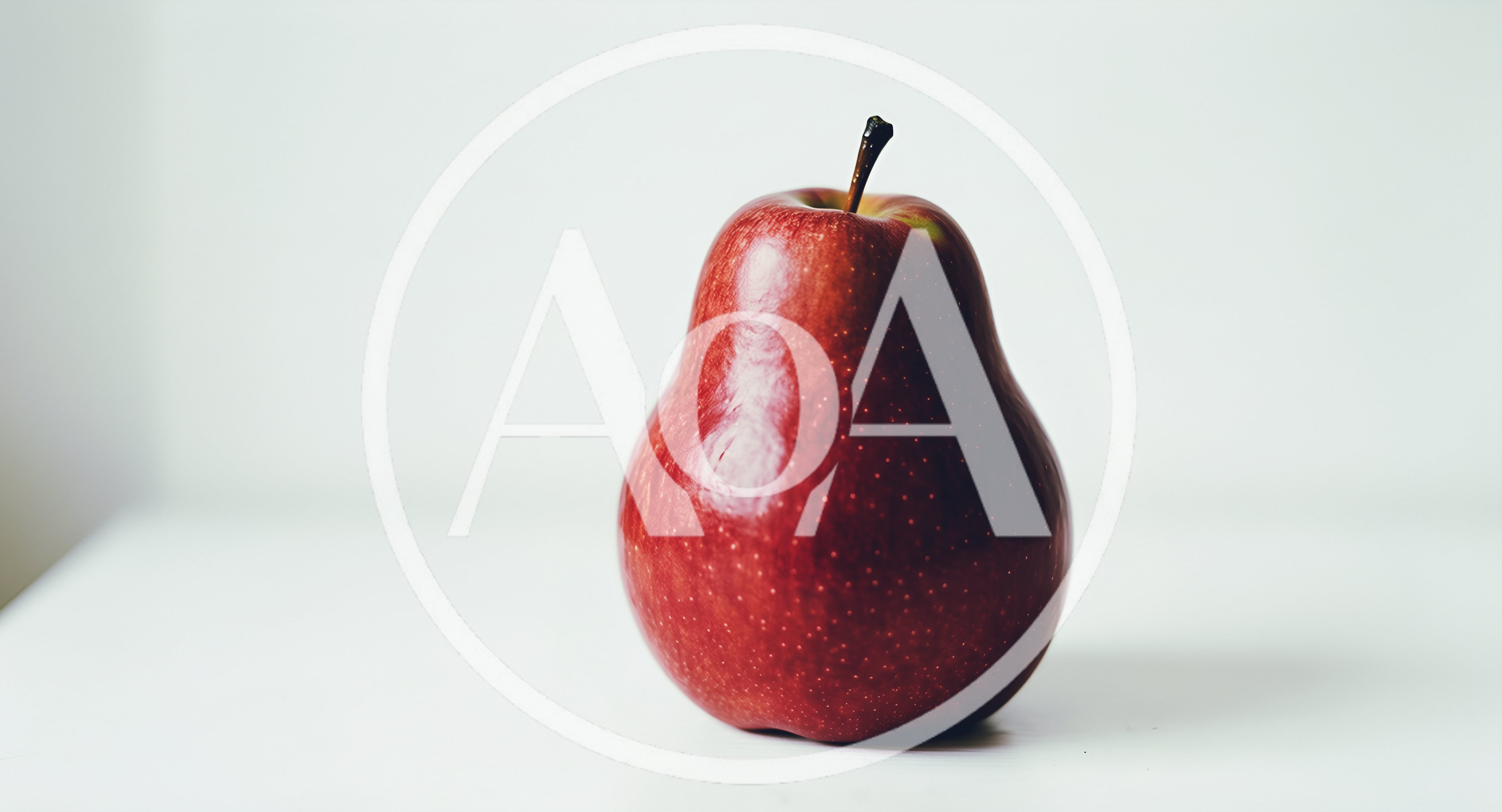 A Single Red Pear On A White Surface