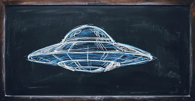 Chalk Drawing Of A UFO On A Blackboard