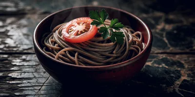 Steaming Bowl Of Soba Noodles With Tomato And Parsley