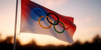 Olympic Flag Waving Against A Sunset Sky