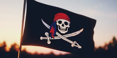 Pirate Flag Waving Against A Sunset Sky