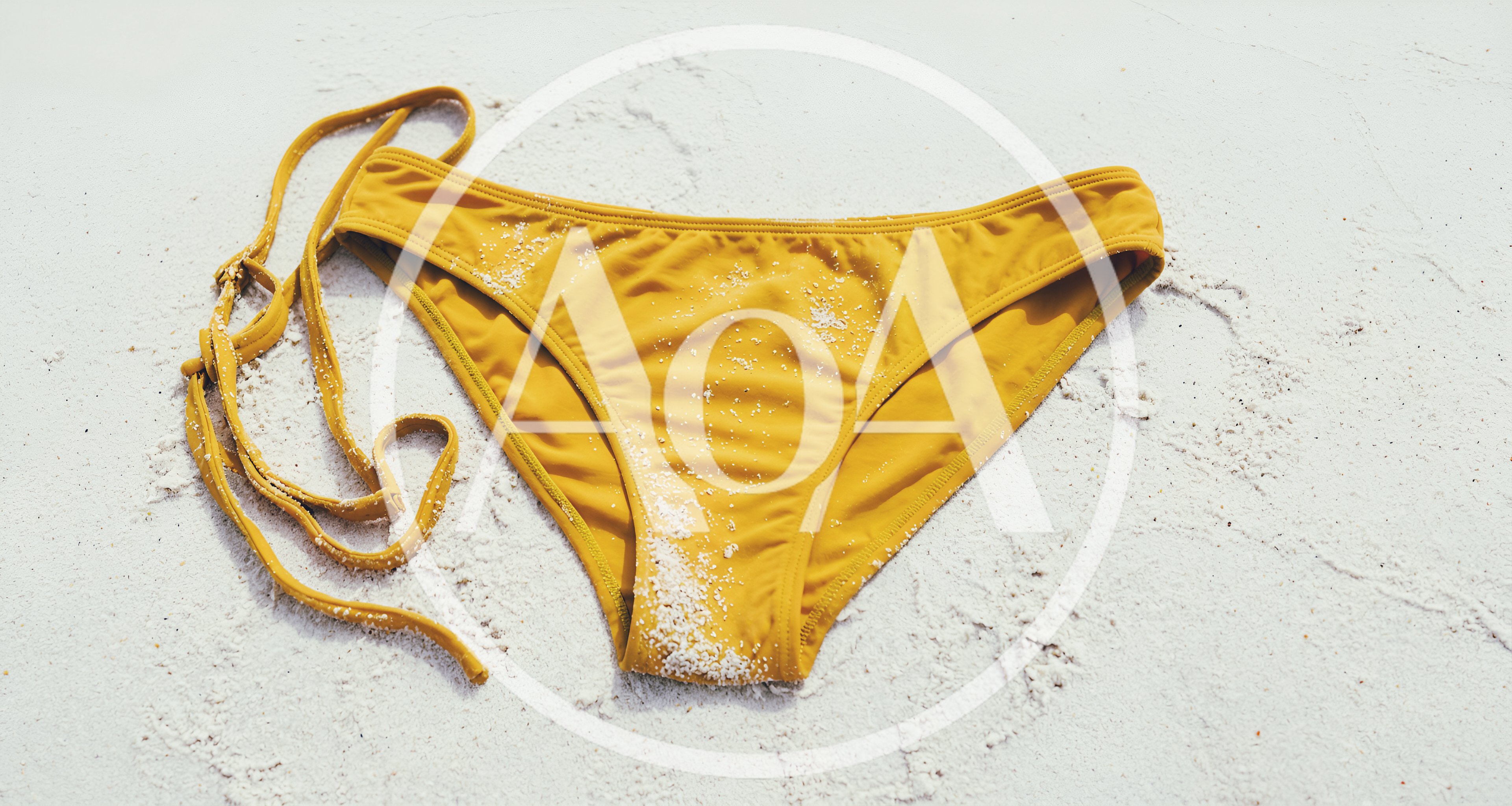 Yellow Bikini Bottoms On White Sand Beach