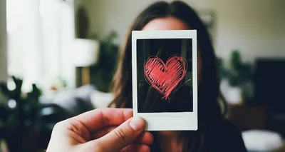 Person Holding A Polaroid Photo With A Red Heart