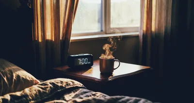 Steaming Coffee Mug On Nightstand At Seven AM
